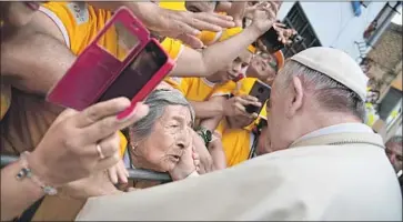  ?? Vincenzo Pinto Associated Press ?? POPE FRANCIS blesses a woman in Trujillo, northern Peru, where he arrived after several days in Chile. His comment on a sexual abuse case in Chile drew criticism, but the issue has not arisen during his days in Peru.