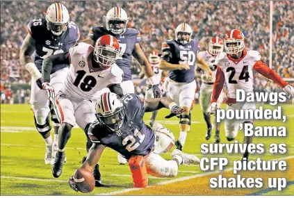  ?? Getty Images; AP ?? ’BURN NOTICE: Kerryon Johnson dives into the end zone for a TD as Auburn routs Georgia 40-17 at home, while one state over, coach Nick Saban (below) and Alabama survivea 31-24 win over Mississipp­i State.