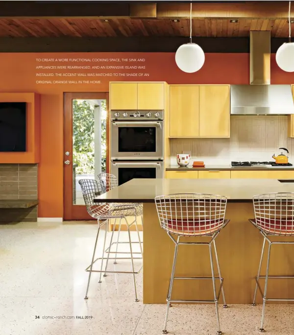  ??  ?? TO CREATE A MORE FUNCTIONAL COOKING SPACE, THE SINK AND APPLIANCES WERE REARRANGED, AND AN EXPANSIVE ISLAND WAS INSTALLED. THE ACCENT WALL WAS MATCHED TO THE SHADE OF AN ORIGINAL ORANGE WALL IN THE HOME.