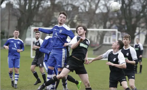  ??  ?? Anto Byrne of Ashford Rovers gets his head to the ball ahead of Evan Moran of Newtown United.