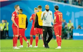  ??  ?? Belgium assistant coach Thierry Henry and Yannick Carrasco after the match. — Reuters