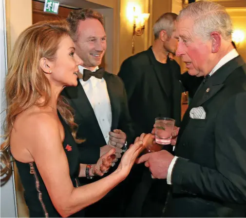  ??  ?? No bottom pinching: Geri Horner and her husband Christian with Prince Charles at the Savoy reception last night