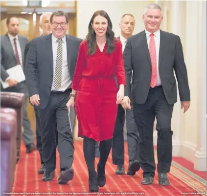 ??  ?? Prime Minister elect Jacinda Ardern arrives at Parliament for her press conference with Grant Robertson, left, and Kelvin Davis, right. Picture / Mark Mitchell