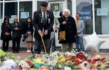  ?? AFP ?? People including a veteran pay their respects at the scene of the fatal stabbing of David Amess at Belfairs Methodist Church on Sunday. —
