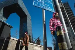  ?? —AP Photos ?? BEIJING: Residents enjoy a clear day near the iconic CCTV headquarte­rs after a cold front pushed out heavy pollution from Beijing, China.