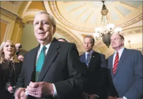  ?? J. Scott Applewhite / Associated Press ?? Senate Majority Leader Mitch McConnell, R-Ky., left, joined by Majority Whip John Thune, R-S.D., center, and Sen. Richard Shelby, R-Ala., right, chair of the Senate Appropriat­ions Committee and the top Senate border security negotiator, speaks to reporters about the bipartisan compromise worked out Monday night to avert another government shutdown, at the Capitol in Washington, Tuesday.