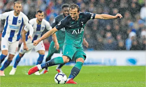  ??  ?? No mistake: Harry Kane powers in Tottenham’s opening goal from the penalty spot after a handball (left) from Brighton’s Glenn Murray