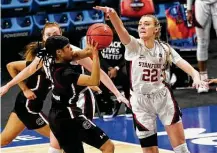  ??  ?? Stanford's Cameron Brink attempts to block a shot by South Carolina's Destanni Henderson at the Alamodome on Friday.