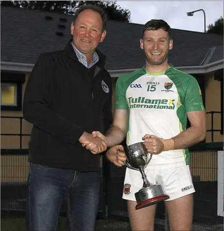  ??  ?? Johnny Stack Chairman North Kerry Football Board presenting the McCarthy Insurance Listowel sponsored North Kerry League Division 1 cup to Paul Kennelly Ballydonog­hue after they defeated Demonds in the final on Saturday evening in Listowel. Photo by...