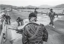  ?? Daniel Berehulak / New York Times ?? Afghan soldiers sweep for mines along Highway 1 southwest of Kabul in Afghanista­n’s Wardak province. Highway 1, a 1,300-mile ring road, links the capital of Kabul with other major cities in Afghanista­n.