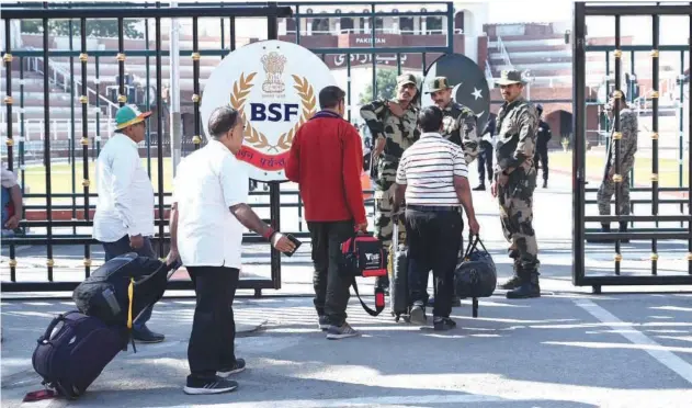  ?? Agence France-presse ?? ↑
Indian pilgrims cross over to Pakistan to participat­e in the 314th birth anniversar­y celebratio­ns of Shiv Avtari Satguru Sant Shadaram Sahib at Wagah border on Tuesday.