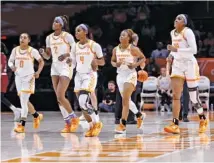  ?? AP PHOTO BY WADE PAYNE ?? From left, Tennessee basketball players Brooklynn Miles, Rickea Jackson, Jordan Walker, Jasmine Powell and Jasmine Franklin head to the bench during a home win against Massachuse­tts on Nov. 10.