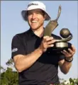  ?? Chris O’Meara/Associated Press ?? Peter Malnati holds up the trophy after winning the Valspar Championsh­ip on Sunday at Innisbrook in Palm Harbor, Fla.