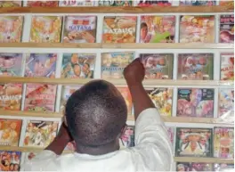  ??  ?? A customer searches for local Hausa films, known as Kannywood, popular among the residents of northern Nigeria’s city of Kano. — AFP