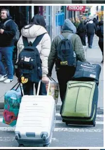  ?? ?? A migrant girl cries (right) as her family leaves (also above) the Row Hotel shelter after Mayor Adams’ 60-day limit for families is up. A new bill under considerat­ion in the state legislatur­e would cancel the policy.