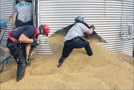  ?? Ross Township Fire Department ?? RESCUE workers in Ohio cut a hole in a soybean bin to reach the trapped Jay Butterfiel­d. “It’s just like being in quicksand,” he said.