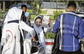  ?? MASSOUD HOSSAINI / AP ?? A member of a girls robotics team shows her U.S. visa as she leaves Kabul on Friday to go to the U.S. The team was allowed entry into the U.S. after President Donald Trump intervened to allow it to take part in a three-day competitio­n.