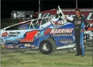  ?? SUBMITTED PHOTO - RICK KEPNER ?? Craig Von Dohren stands with the checkered flag after his 100th career modifiedwi­n at Grandviewo­n Aug. 20.