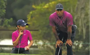  ?? Mike Ehrmann / Getty Images ?? Charlie Woods may or may not have given sideeye to father Tiger on the 14th hole. But there must be some reason they didn’t use Tiger’s tee shots much. “I don’t really care about my game,” said the taller guy who doesn’t get a weekly allowance. “I’m just making sure that Charlie has the time of his life. And he’s doing that.”