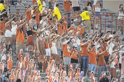  ?? CHUCK BURTON/ AP ?? Longhorns football fans join in singing “The Eyes of Texas” after Texas defeated Texas- El Paso in September.