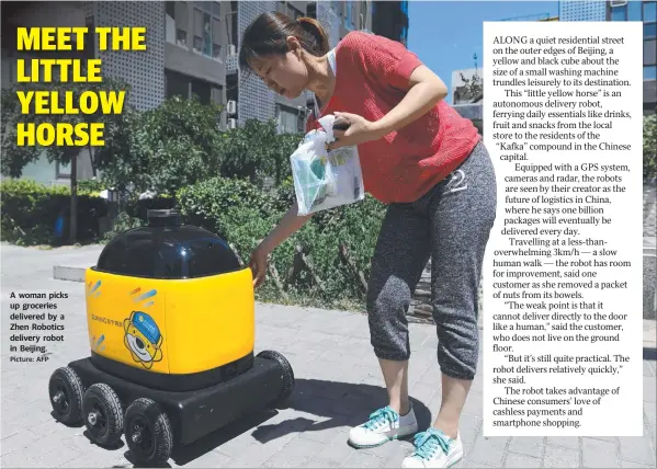  ?? Picture: AFP ?? A woman picks up groceries delivered by a Zhen Robotics delivery robot in Beijing.