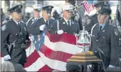  ?? JOHN MINCHILLO — THE ASSOCIATED PRESS ?? A memorial flag is brought onto the stage Saturday during ceremonies to commemorat­e the 20th anniversar­y of the Sept. 11 terrorist attacks at the National September 11 Memorial & Museum in New York.