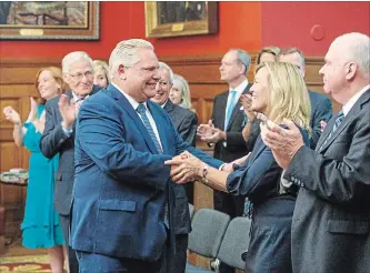  ?? MARK BLINCH THE CANADIAN PRESS ?? Doug Ford greets Christine Elliott before he is sworn in as premier of Ontario during a ceremony at Queen's Park in Toronto on Friday. Elliott was named deputy premier and minister of health and long-term care.