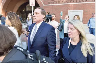  ?? Josh Reynolds / Associated Press ?? John Wilson, center, and his wife, right leave federal court after he was found guilty of participat­ing in a fraudulent college admissions scheme Friday in Boston. Wilson and another wealthy parent Gamal Abdelaziz, were convicted Friday of buying their kids’ way into school as athletic recruits in the first case to go to trial in the college admissions cheating scandal that embroiled prestigiou­s universiti­es across the country.