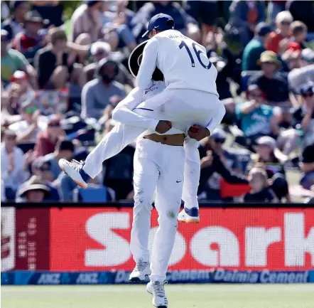  ?? AP ?? Ravi Jadeja, left, gets a hug from team-mate Mayank Agarwal after his brilliant catch to dismiss Neil Wagner.