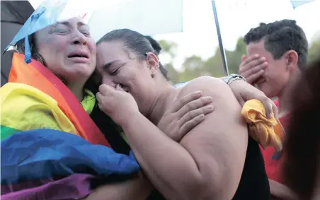  ?? PICTURE: REUTERS ?? SHARED LOSS: Friends of Juan Carlos Nieves Rodriguez, one of the victims of the shooting at the Pulse night club in Orlando, Florida, mourn during his funeral in Puerto Rico on Monday.