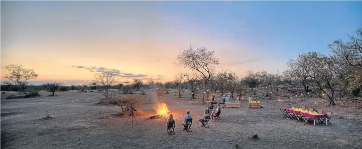  ?? © AZURA LODGE ?? BUFFET BOUNTY: Guests wait for the stargazing at a bush dinner at Azura Selous Game Reserve, above, and some oxpeckers have their bush snack off a hippo