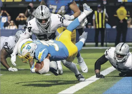  ?? Robert Gauthier Los Angeles Times ?? AUSTIN EKELER and the Chargers held on to beat Jonathan Abram and the Raiders in Sunday’s season opener. Another challengin­g AFC West test on short rest awaits in Kansas City, where the high-scoring Chiefs have won the division title six years running.