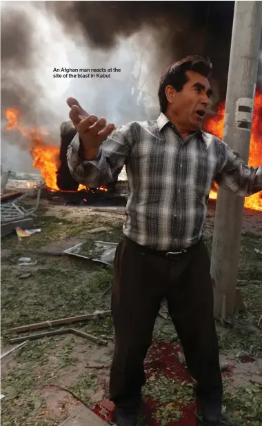  ??  ?? An Afghan man reacts at the site of the blast in Kabul