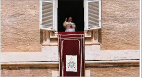  ?? SPENCER PLATT / GETTY IMAGES ?? Pope Francis gives a short speech followed by the Angelus from the window of his apartment over St. Peter’s Square on Sunday.