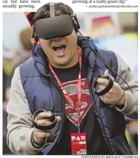  ?? STAFF PHOTO BY NICOLAUS CZARNECKI ?? ‘SOMETHING MAGICAL’: Dan Ban enjoys a game of Jousting in virtual reality during PAX East at the BCEC in the Seaport District yesterday.