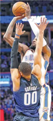  ?? [PHOTO BY NATE BILLINGS, THE OKLAHOMAN] ?? Oklahoma City’s Paul George shoots against Orlando’s Aaron Gordon during Monday’s game at Chesapeake Energy Arena.