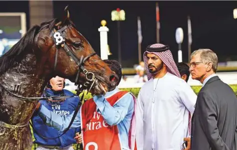  ?? Virendra Saklani/Gulf News ?? Trainer Saeed Bin Surour and his assistant Bryan Brown with Naaeebb, winner of the Emirates A380 Handicap on the opening night of new racing season 2017-18 at Meydan Racecourse on Thursday night.
