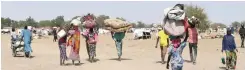  ?? | African News Agency (ANA) ?? INTERNALLY displaced villagers carry their belongings. Most displaceme­nt associated with conflict in Cameroon has historical­ly occurred in the Far North, the poorest region of the country and the one that suffers the most from the Boko Haram insurgency.