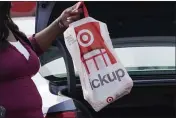  ?? ROGELIO V. SOLIS — THE ASSOCIATED PRESS ?? A Target employee places a curbside pickup purchase into the trunk of a customer in Jackson, Miss.
