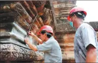  ?? MAO PENGFEI / XINHUA ?? Chinese specialist help renovate Ta Keo Temple at the Angkor comlpex in Cambodia in July.
