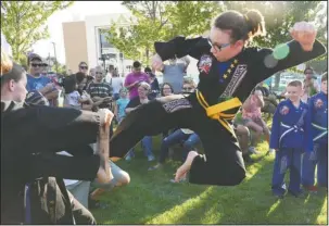  ?? The Sentinel-Record/Grace Brown ?? KARATE KID: Kayla Allen, 12, of Hot Springs, kicks a board Monday during the inaugural Halfway to St. Patrick’s Day Pop Up Pub Party, held on the Hot Springs Convention Center lawn to celebrate that only six months remain until the annual parade on March 17.