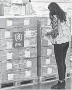  ?? SAMUEL HABTAB/ AFP VIA GETTY IMAGES ?? A WHO worker checks health supplies in Addis Ababa, Ethiopia, on Tuesday.