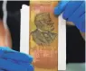  ?? JOHN MCDONNELL/WASHINGTON POST ?? A ribbon with a portrait of Robert E. Lee from the 1880s found Tuesday in the second time capsule discovered at the former site of the general’s statue in Richmond, Va.
