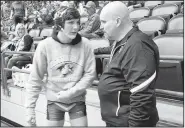  ?? NWA Democrat-Gazette/PAUL BOYD ?? Bentonvill­e assistant wrestling coach Bill Desler (right) talks to his son, Nathan, before one of his matches in the Class 6A-7A Arkansas High School State Wrestling tournament in Little Rock. Desler will be honored for his “Lifetime Service to...