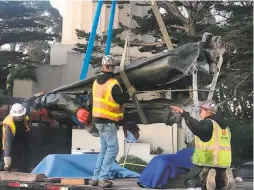  ?? San Francisco Recreation and Park Department ?? A city crew removes the Columbus statue at Coit Tower early Thursday morning. A flyer had called on protesters to throw it into the bay.