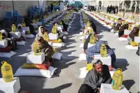  ?? AFP ?? Afghan refugees deported from Pakistan received food aid by the Red Cross Society in Kandahar on January 24, 2024.—