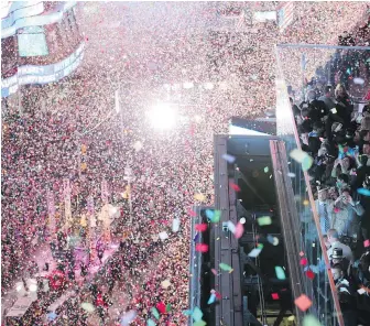  ??  ?? Confetti flies over New Year’s Eve revellers in New York’s Times Square after the clock strikes midnight. New Year's Eve is the party of the year for many, but what happens when your dreams are too big for your budget? For one, money experts say, be...