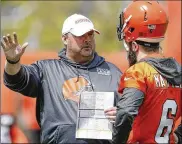  ?? RON SCHWANE / AP ?? Cleveland Browns coach Freddie Kitchens talks to his QB on the rise, Baker Mayfield, during a session last month at the team’s training facility in Berea.