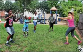  ?? MICHILEA PATTERSON — DIGITAL FIRST MEDIA ?? Fitness instructor Joanne Pritchard far right, leads kids in a fitness program called Pound that uses drum sticks during the 2nd Annual Pottstown Community Field Day at Chestnut Street Park on Saturday.