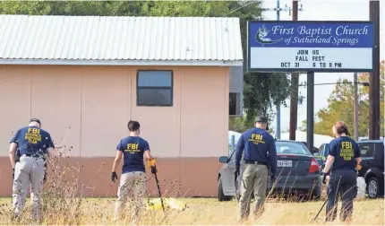  ??  ?? FBI agents look for evidence in a field next to the First Baptist Church in Sutherland Springs, Texas, on Monday. Associate pastor Bryan Holcombe was among those killed in Sunday’s shooting attack. COURTNEY SACCO/USA TODAY NETWORK